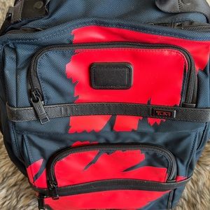 Tumi navy and red backpack.